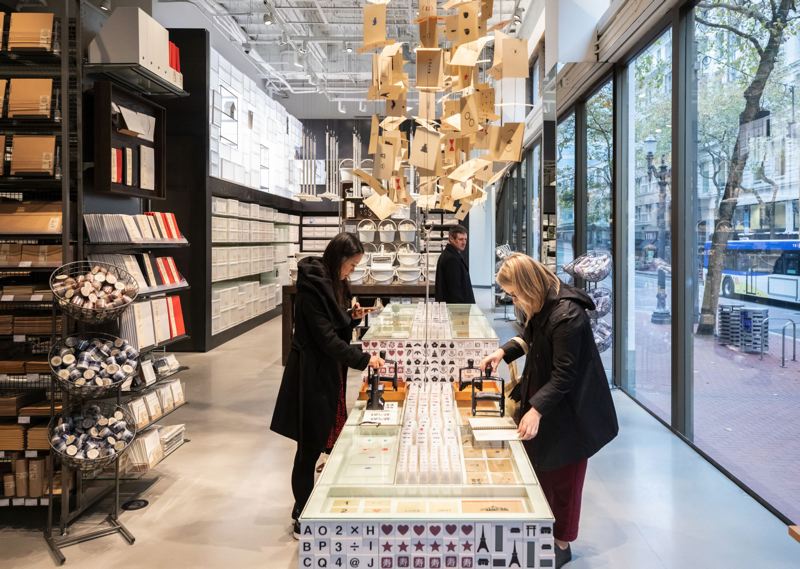 TRIBUNE PHOTO: JONATHAN HOUSE - Invitees at a media-only preview held one day before the Muji grand opening on Nov. 17 check out various stamps for gift wrapping.