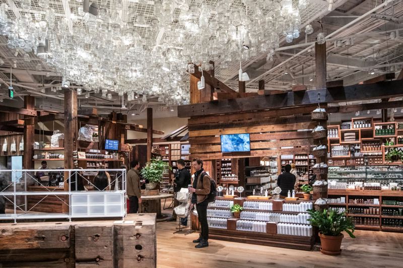 TRIBUNE PHOTO: JONATHAN HOUSE - The interior of Muji in the Meier & Frank Building features locally sourced wood, including 204 reclaimed old-growth timbers.