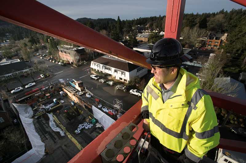 REVIEW PHOTO: JAIME VALDEZ - Miles Haladay, managing partner at 10 Branch, looks out over the Beacon Lake Oswego project IN December from a crane in downtown Lake Oswego.