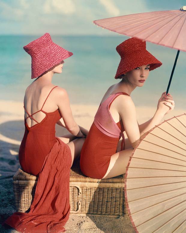 Two models seated on a wicker basket at the beach, published in Vogue in 1959 Two models seated on a wicker basket at the beach, published in Vogue in 1959