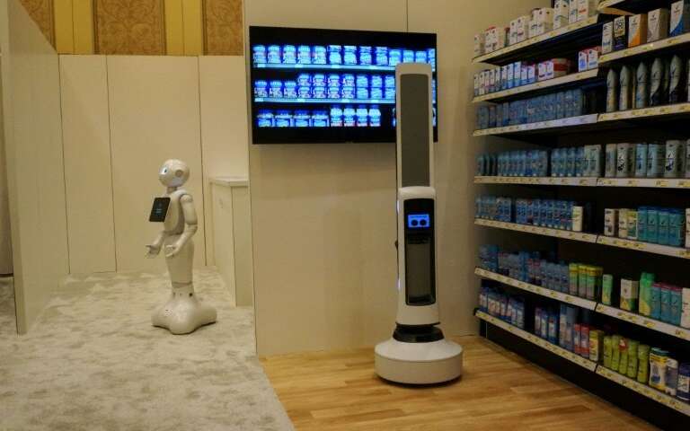 Pepper of SoftBank Robotics (L) and Tally of Simbe Robotics (R) are teaming up to work with retailers: Pepper interacts with cus